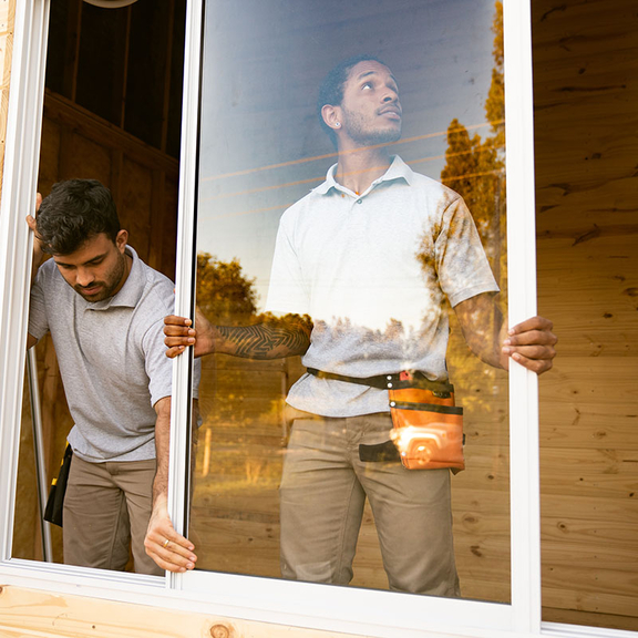 Contractors installing a new window