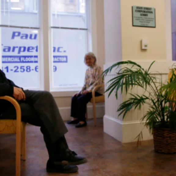 Older adults sitting in waiting room.