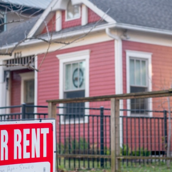 For-rent sign in yard.