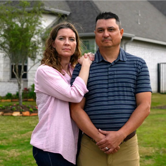Couple standing infront of a house