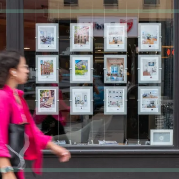 Woman passing by a rental window