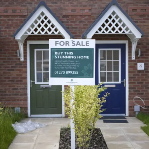 House with a for sale sign.