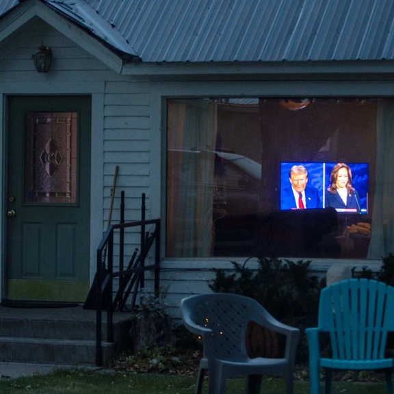 House with presidential debate seen through living room window