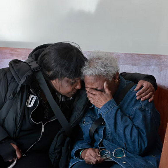 Woman being comforted by a friend.