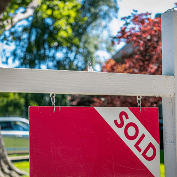 Sold sign in front of a home.