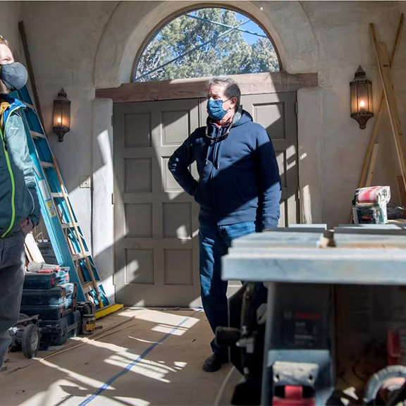 Workers inside a home being remodeled.