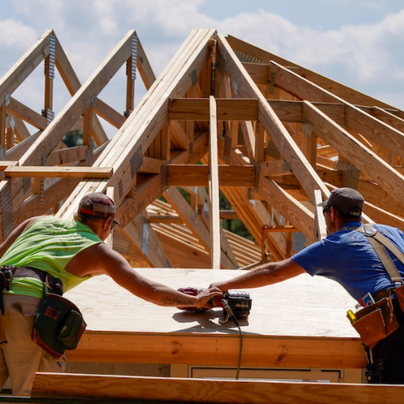 Workers building a house.