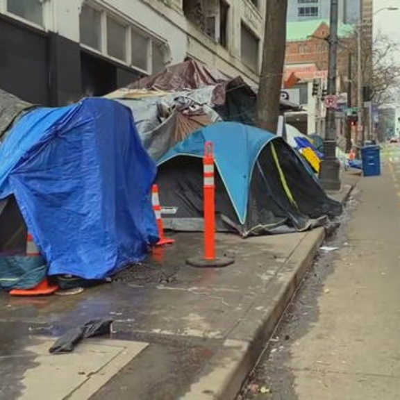 Tents on a city sidewalk.