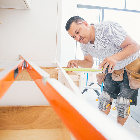 Contractor measuring kitchen counters for a remodeling project