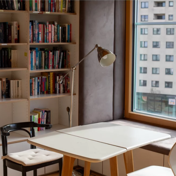 Table and bookshelves in an apartment.