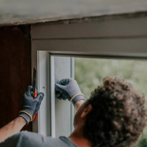 Person repairing a window.