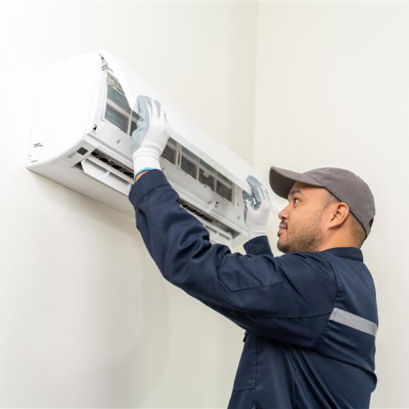 Technician working on a heat pump