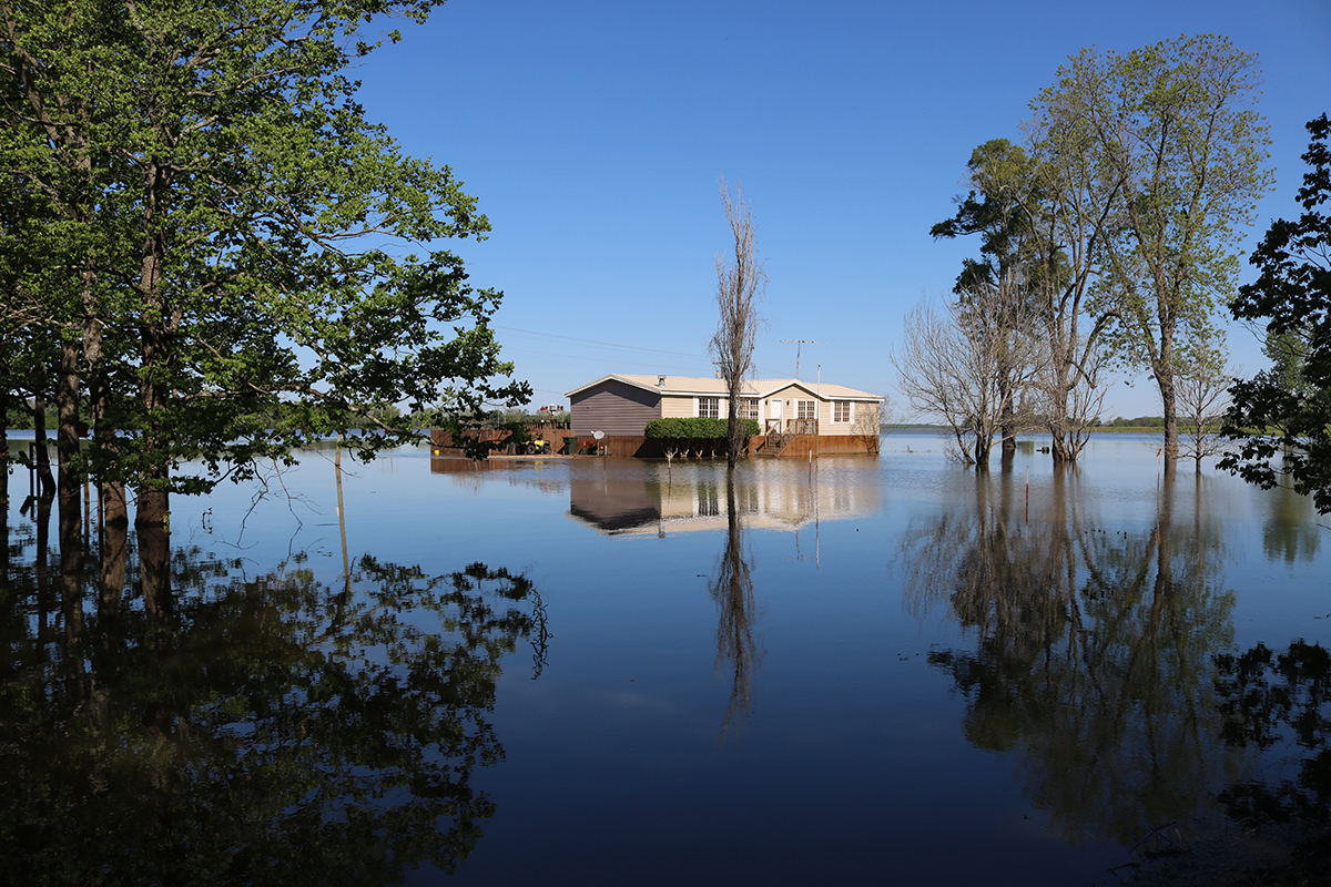 A small house surrounded by floodwater.