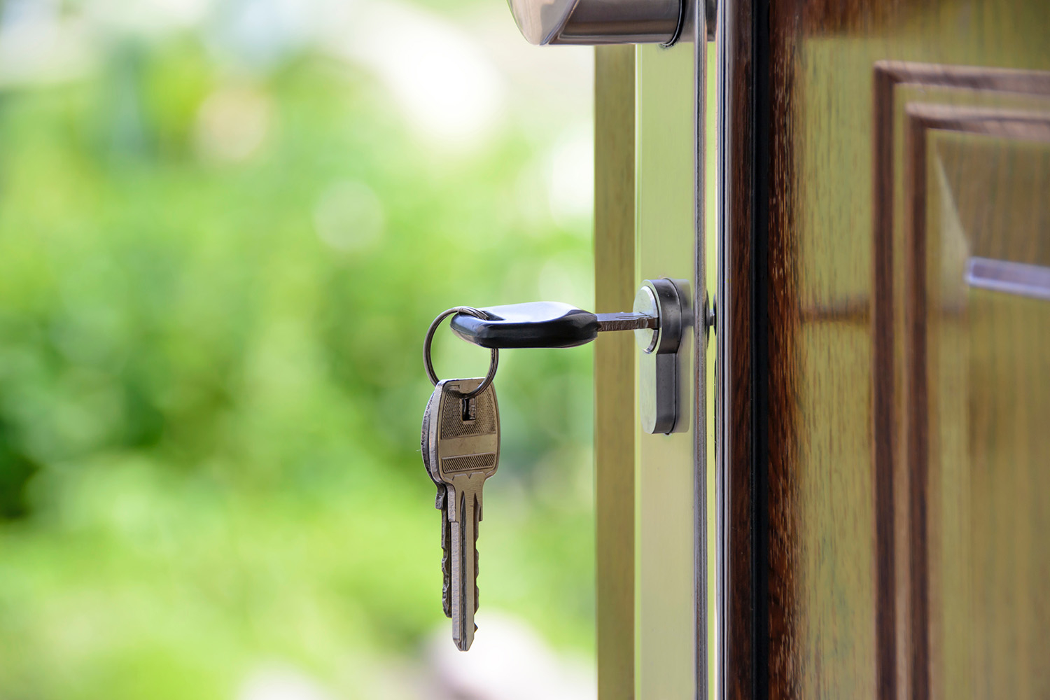 Key in open door of home.