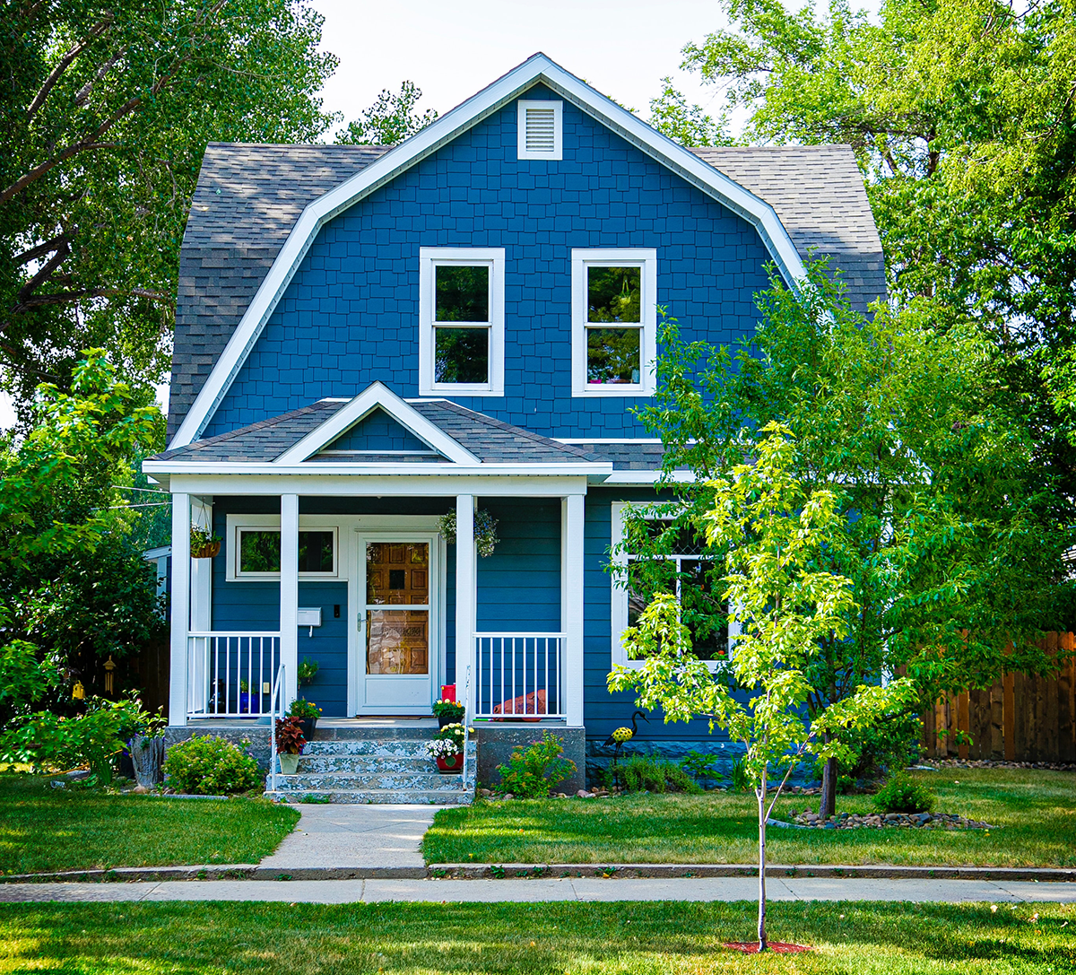 View of a small home with yard.