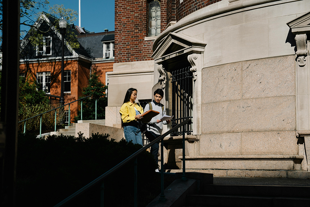 Two students walking on campus