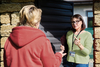 Social worker talking to a woman outdoors.