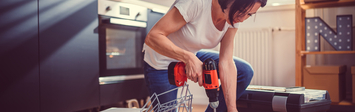 Woman using cordless drill