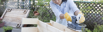Woman building a wooden bench