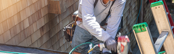 Roofer working on partially finished roof.