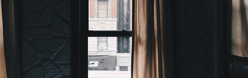 Apartment window looking out on the street.