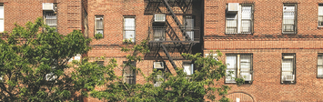 View of apartment building with air conditioners.