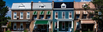 Four rowhouses facing street.