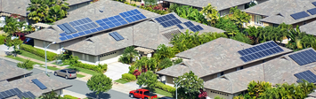 Neighborhood of ranch homes with solar panels.