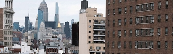 View of NYC skyline and apartment buildings.