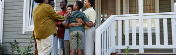 Family assembled on front steps of home.