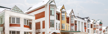 View of snowy apartment complex.