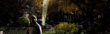 Man walking past "now leasing" sign.