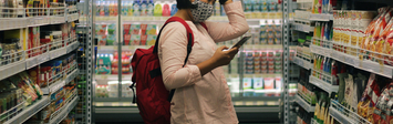 Person standing in grocery store aisle.