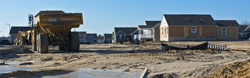 View of lot with half-constructed homes.