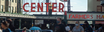 Crowd walking in public market in Seattle.