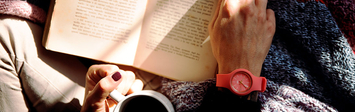 Person reading with a cup of coffee