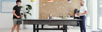 Two people playing ping pong.
