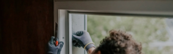 Person repairing a window.