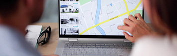 Couple looking at real estate listings online.