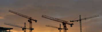Cranes above apartment buildings under construction.